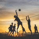 silhouette of people playing basketball during sunset