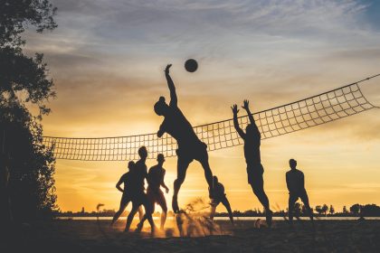 silhouette of people playing basketball during sunset